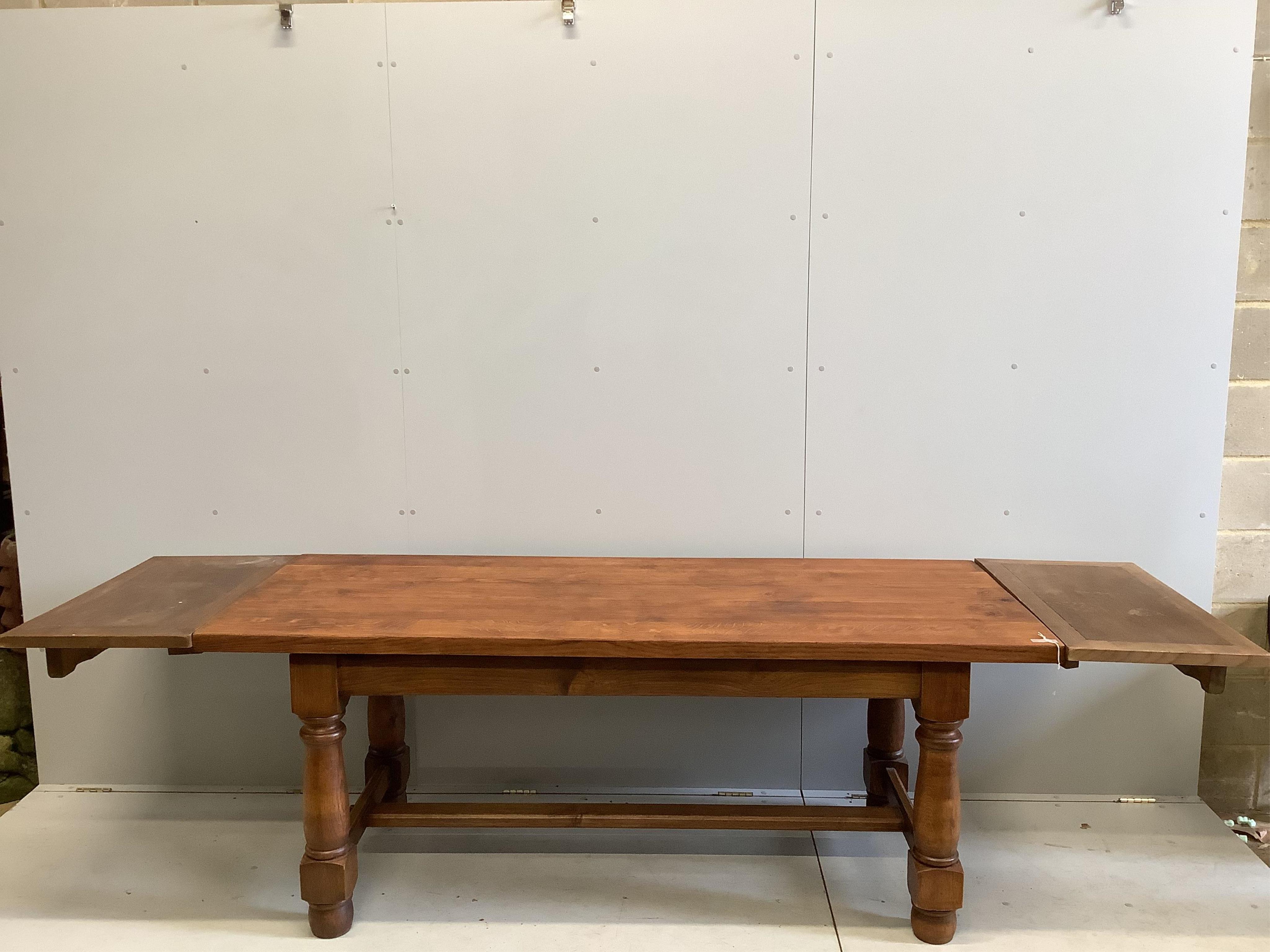 An 18th century style rectangular oak refectory dining table, (extending leaves added later), width 200cm, depth 79cm, height 77cm